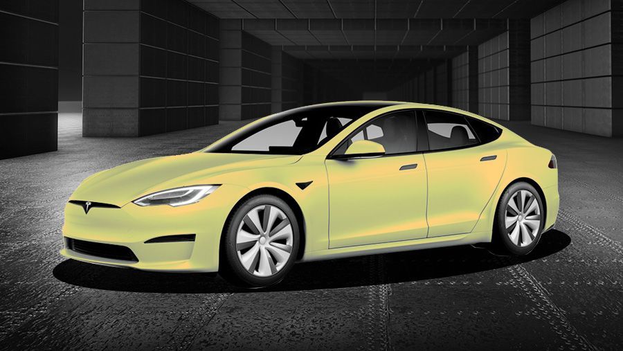 A yellow tesla model s is parked in a garage.