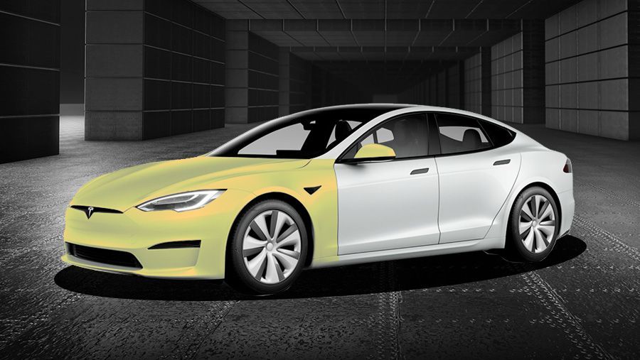 A white tesla model s is parked in a garage.