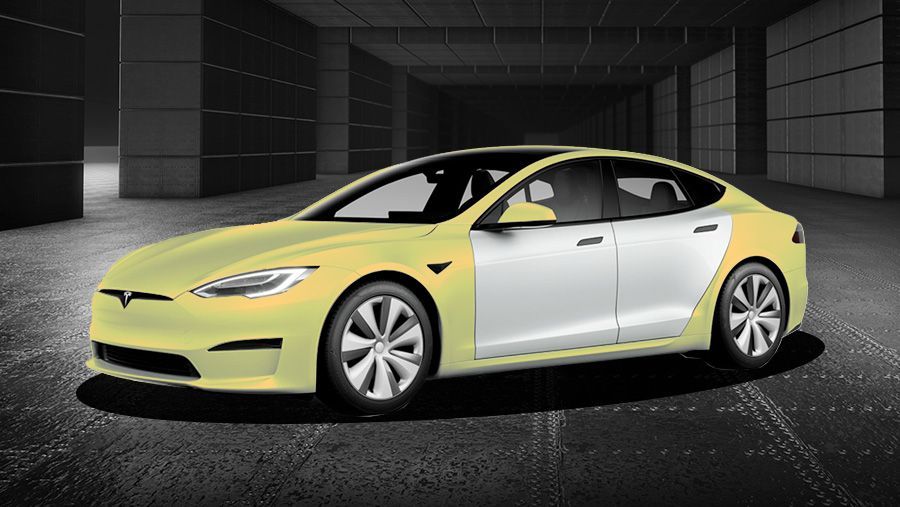 A yellow and white tesla model s is parked in a garage.