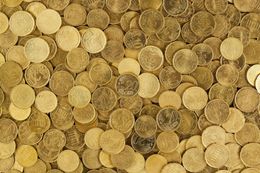 A pile of gold coins with a few missing