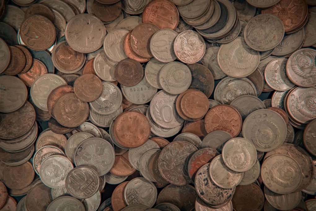 A pile of old coins stacked on top of each other on a table.