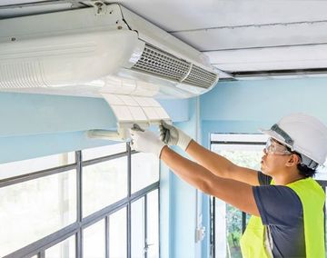 Technician repairing Air Conditioner - Heating and Air Conditioning in Chicago, IL