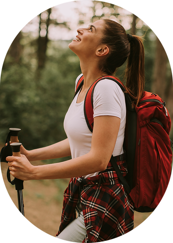a woman with a red backpack and hiking poles