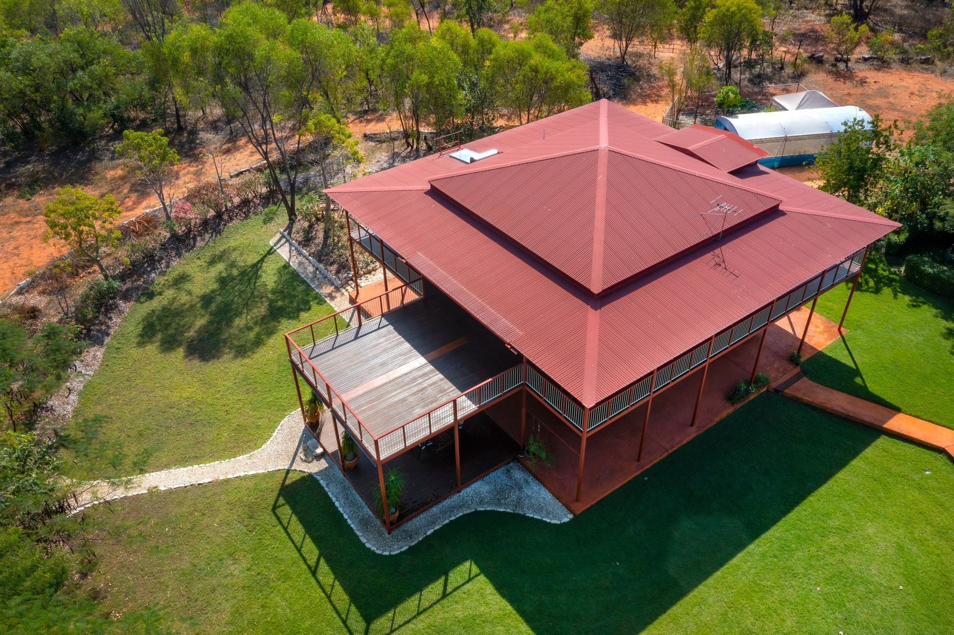 Aerial View of a Large, Red-roofed House With a Wraparound Deck — Callaway Roofing & Construction in Orange, NSW
