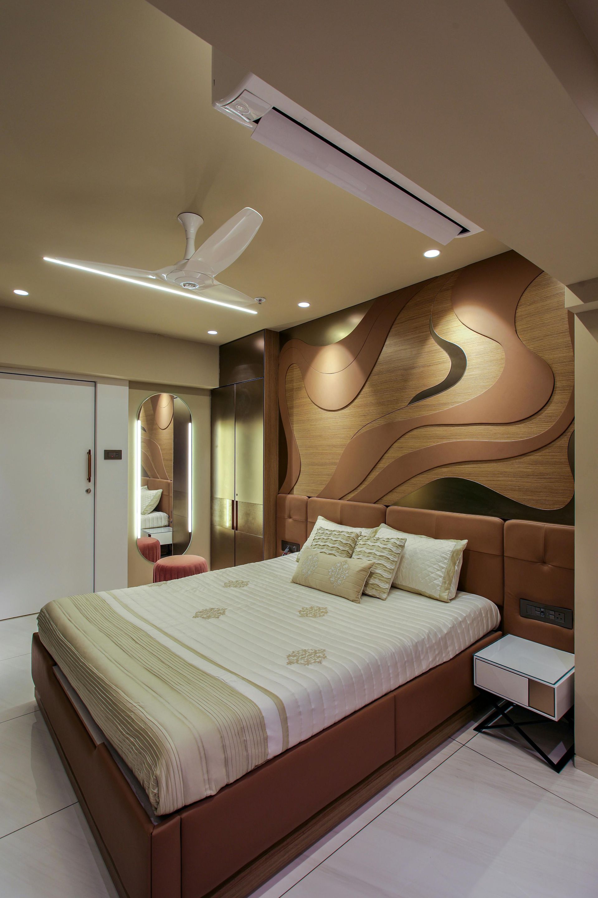A bedroom with a large bed and a ceiling fan.