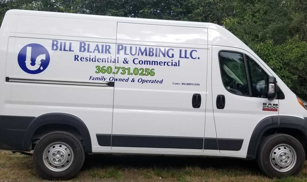 A white van for bill blair plumbing llc is parked in the grass.