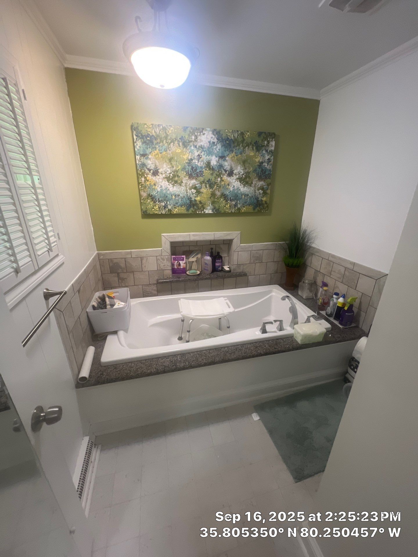 Bathroom before remodel showing standard bathtub and surrounding tile prior to ADA conversion.