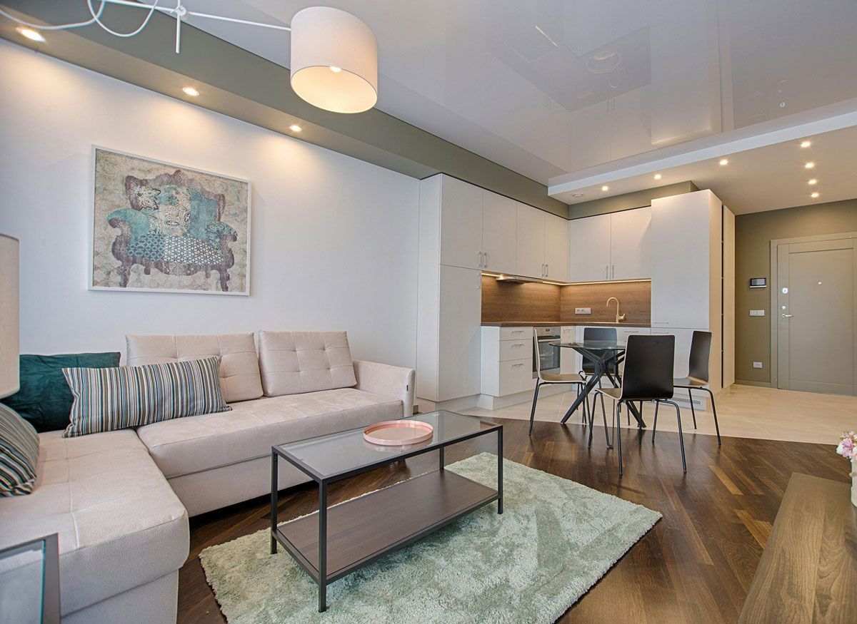 A living room with a couch , coffee table and rug.