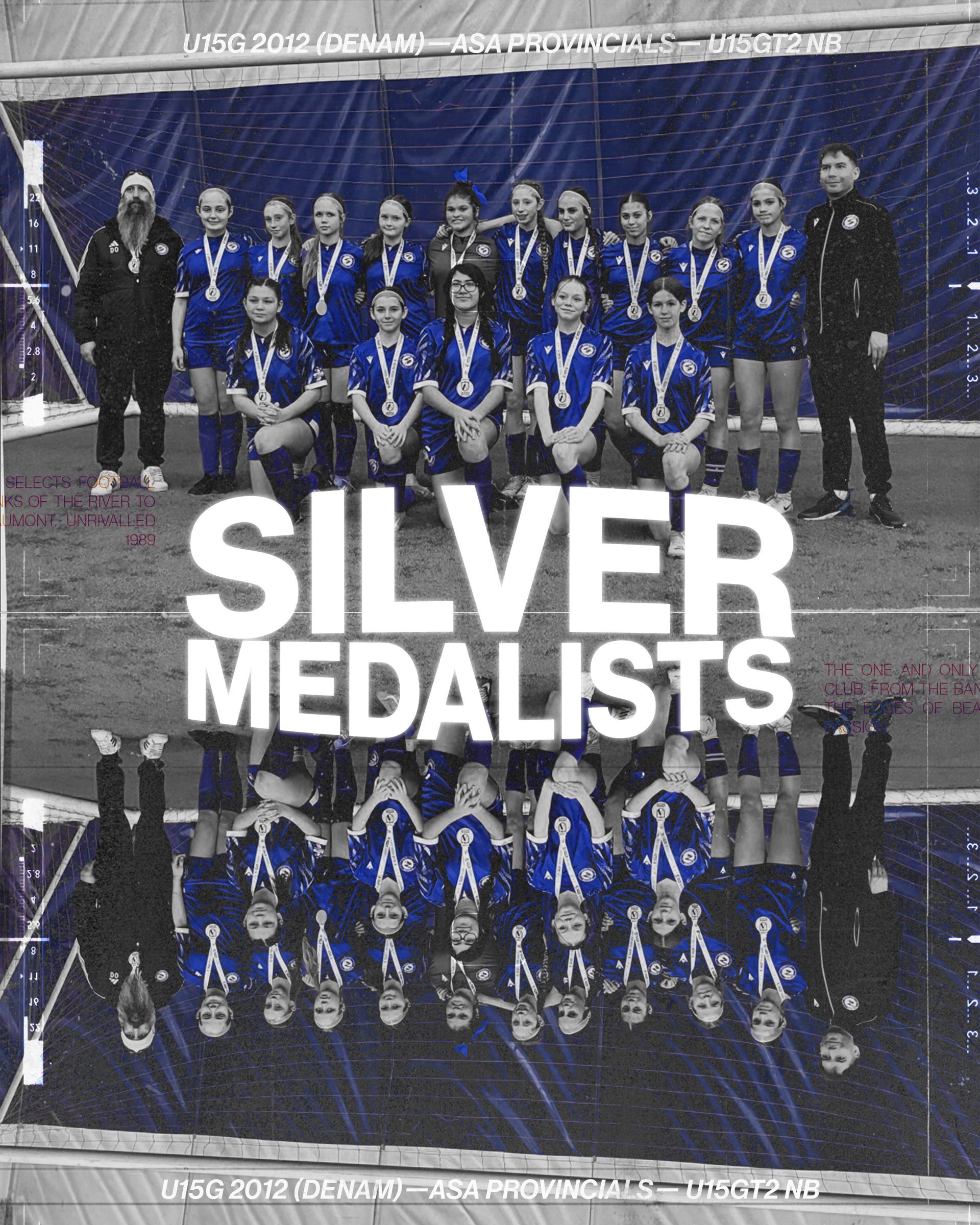 A team of soccer players in blue jerseys wearing silver medals, posed with two coaches in front of a dark backdrop.