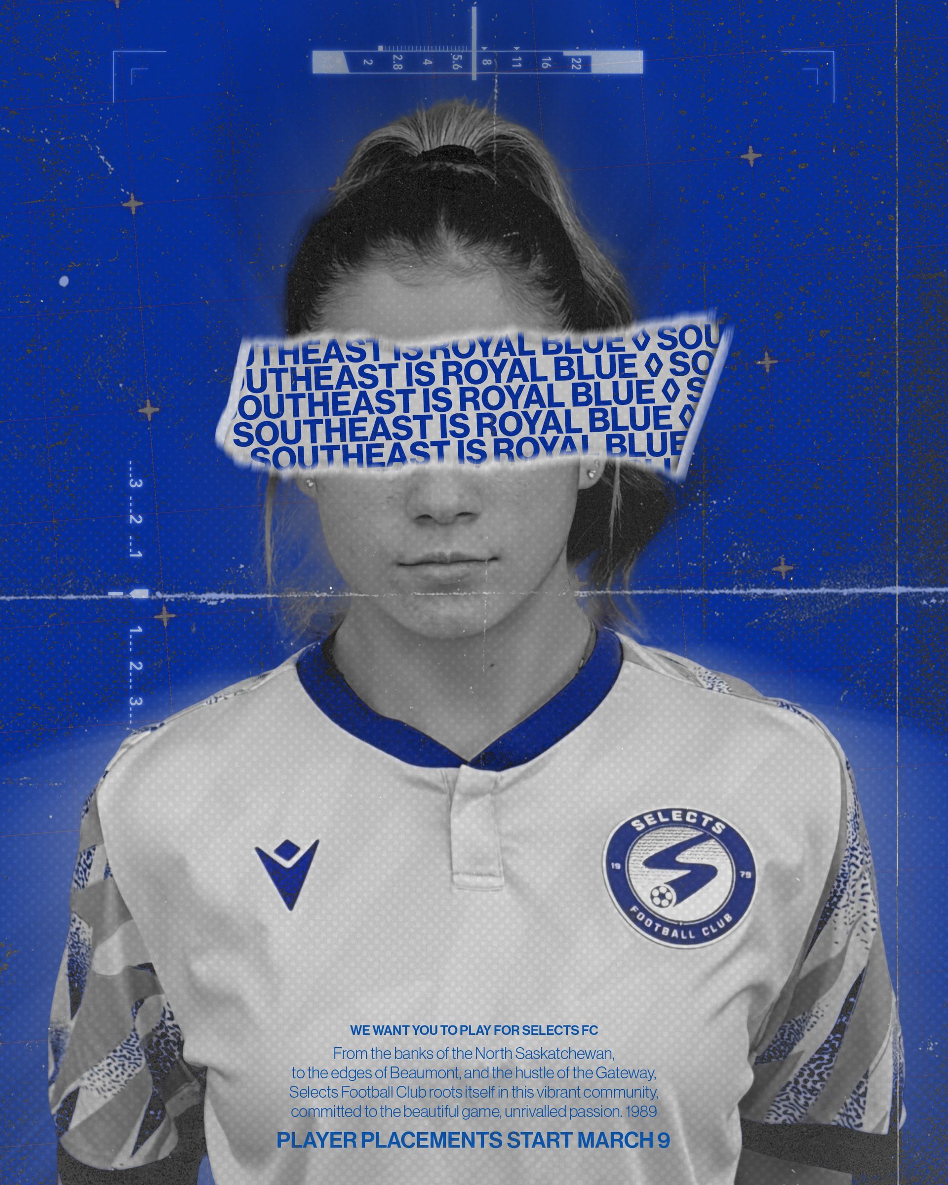 A person in a white and blue sports jersey with a torn strip over their eyes reading 