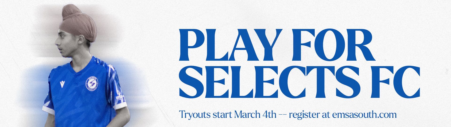 A man in a blue shirt is standing in front of a sign that says play for selects fc