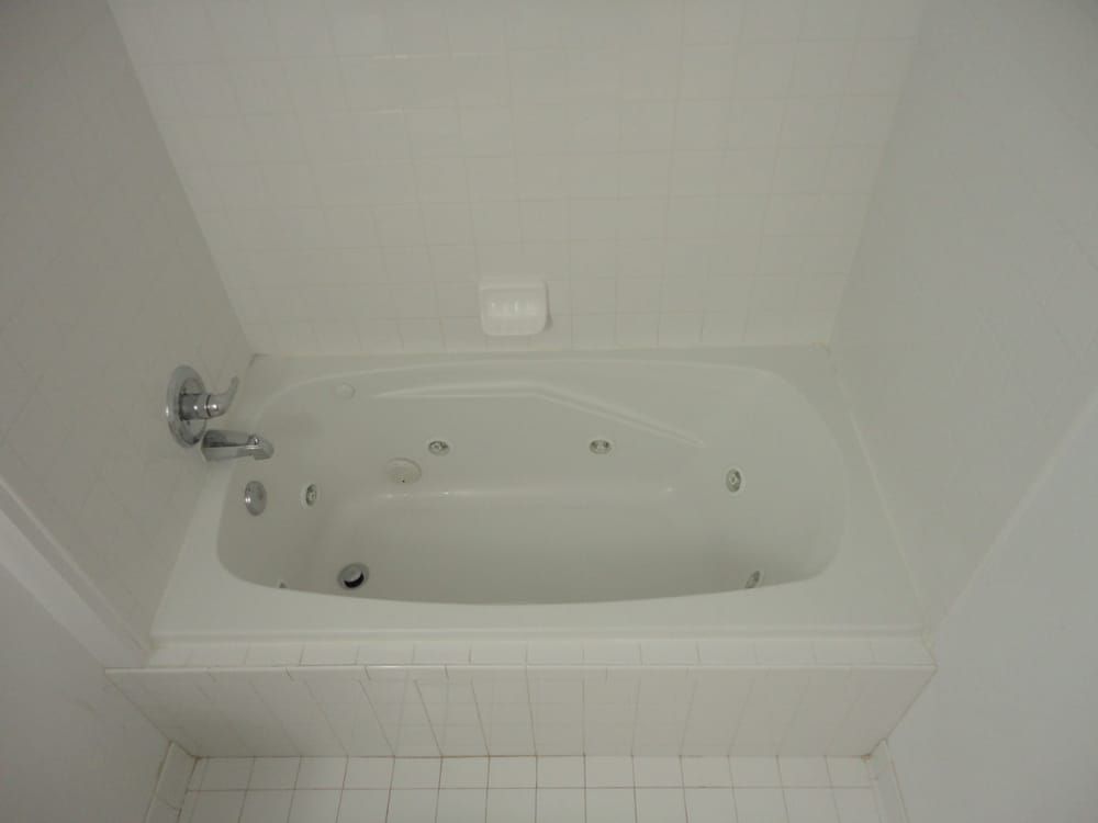 There is a jacuzzi tub in the bathroom.