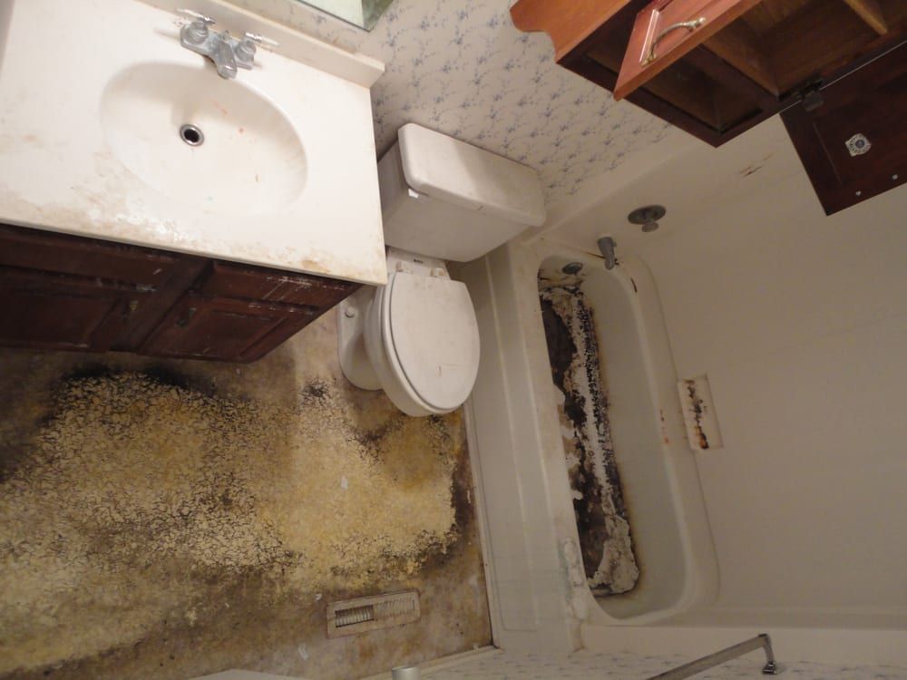 A bathroom with a toilet a sink and a bathtub