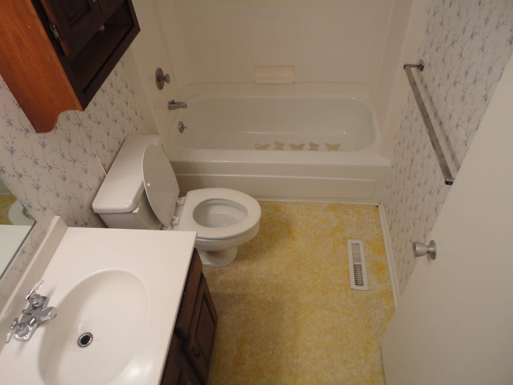 A bathroom with a toilet , sink and bathtub