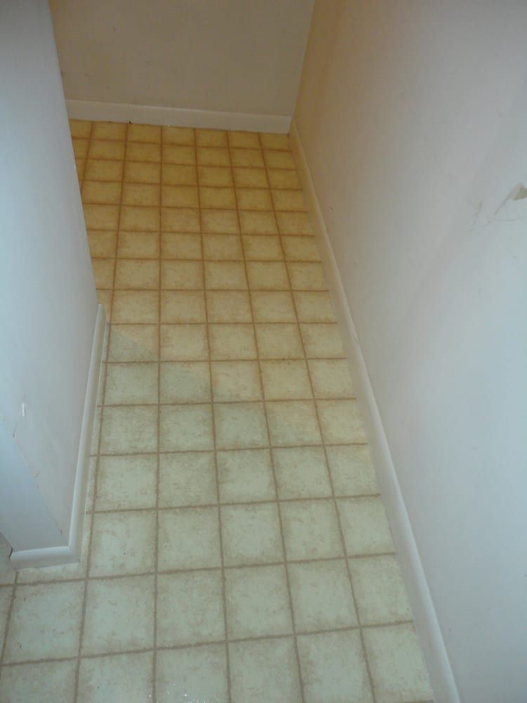 A hallway with a tiled floor and white walls