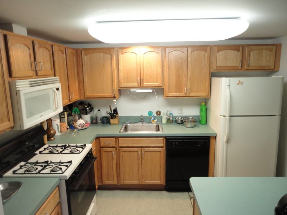 A kitchen with wooden cabinets and a white refrigerator
