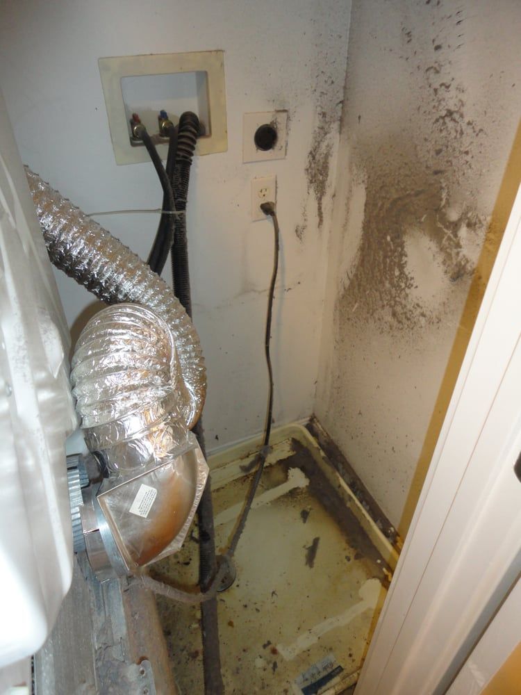 A dirty room with a hose and electrical cords