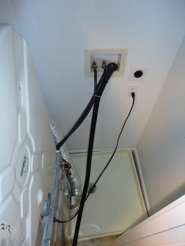 A washer and dryer with a hose attached to it