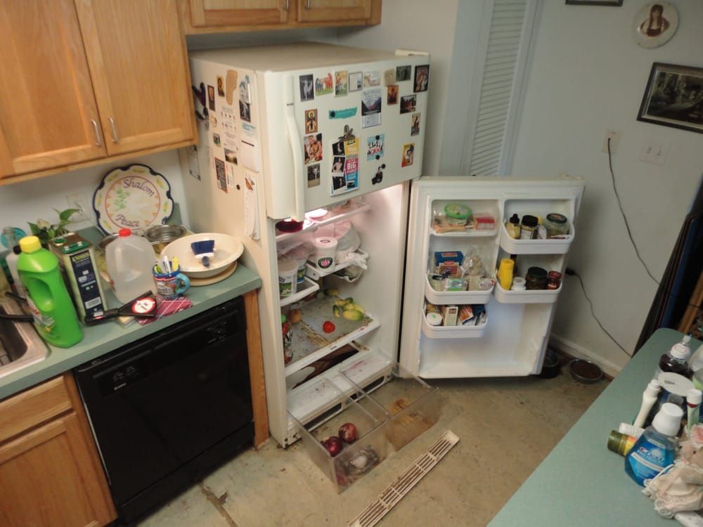 A kitchen with a refrigerator that is open