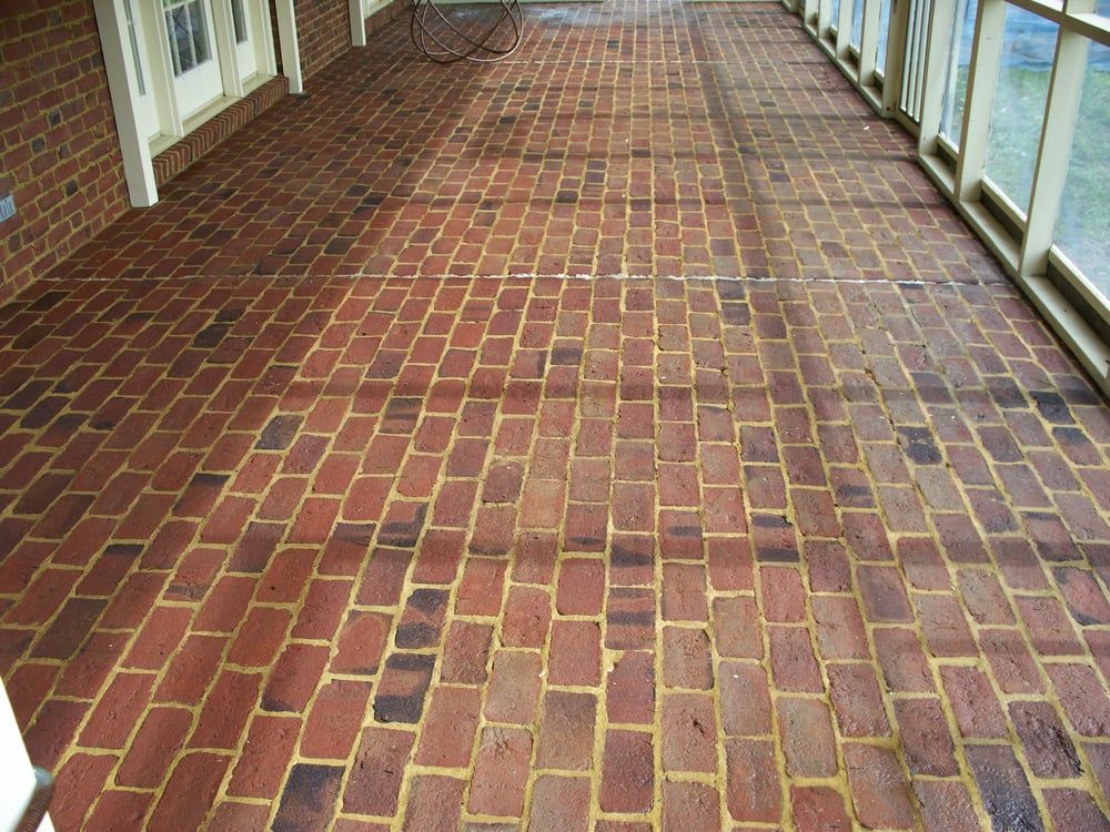 A brick porch with a bicycle on it