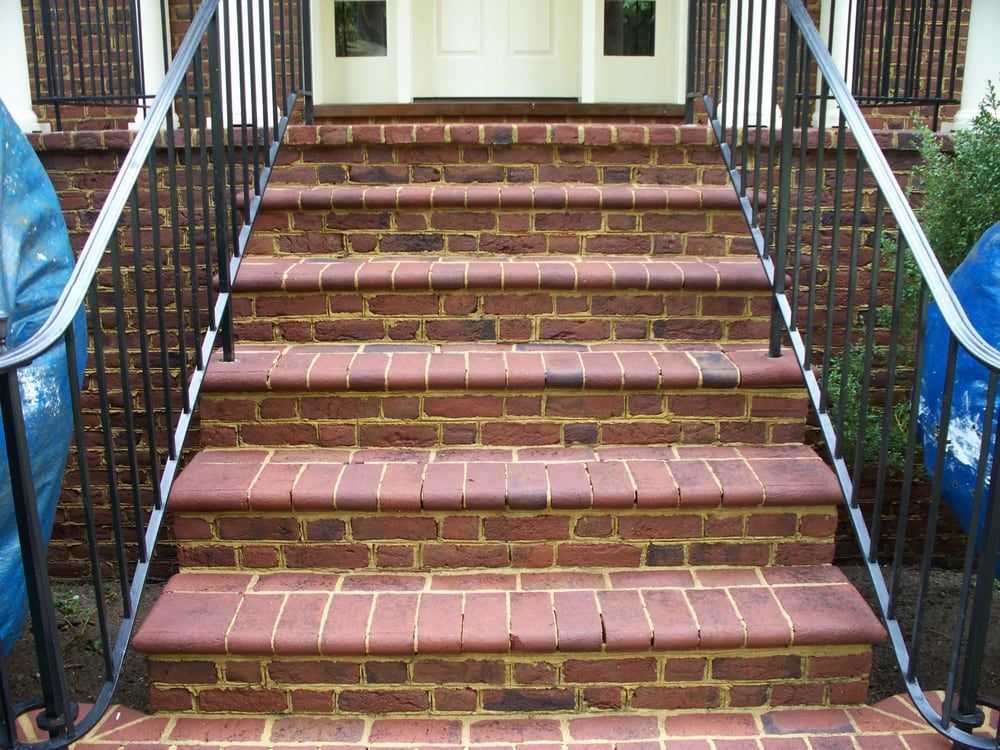 A set of brick stairs leading up to a white door