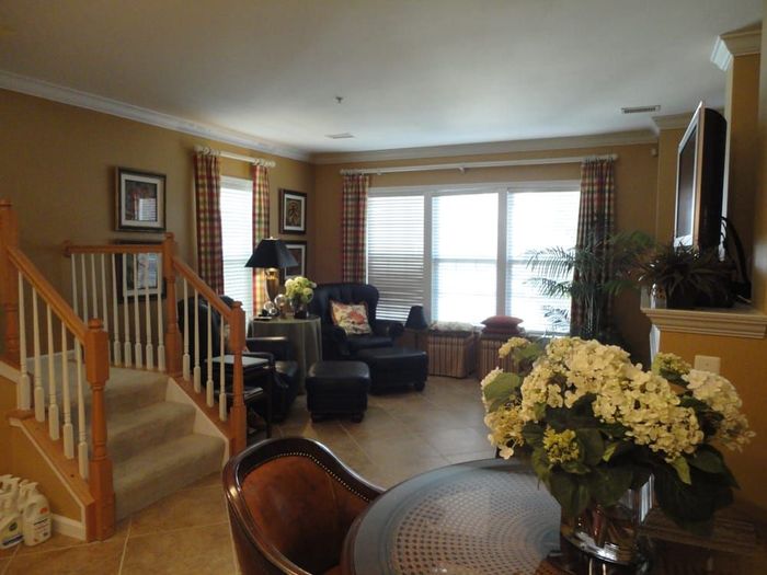 A living room with a table and chairs and stairs