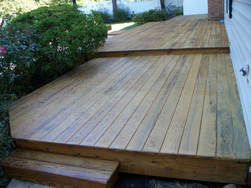 A wooden deck with stairs leading up to it