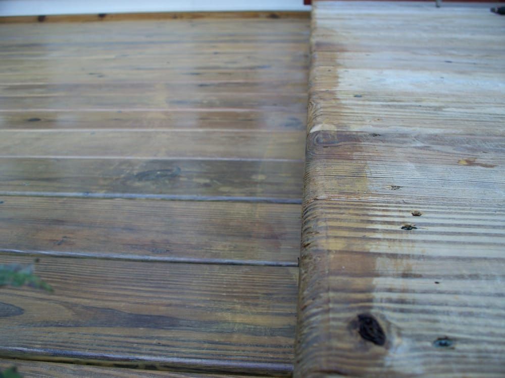 A close up of a wooden floor with a stain on it.