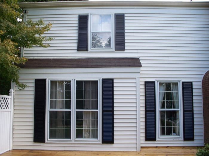 A white house with black shutters on the windows