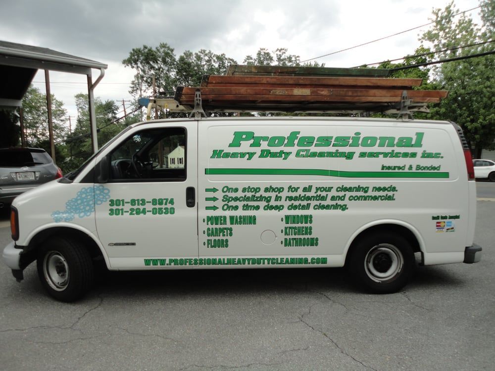 A professional heavy duty cleaning service van is parked in a parking lot