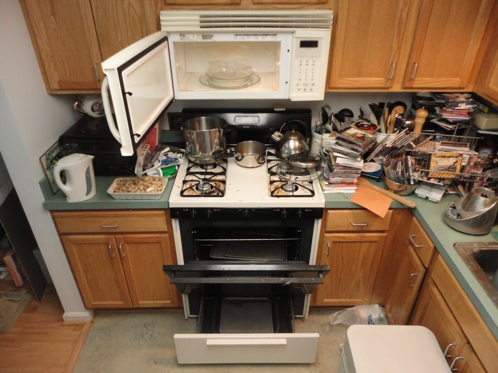 A kitchen with a stove top oven and a microwave