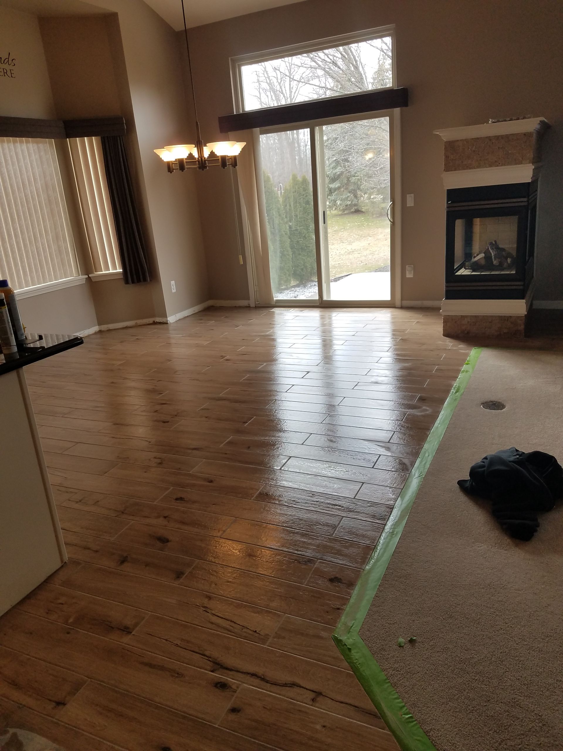 A living room with hardwood floors and a fireplace.
