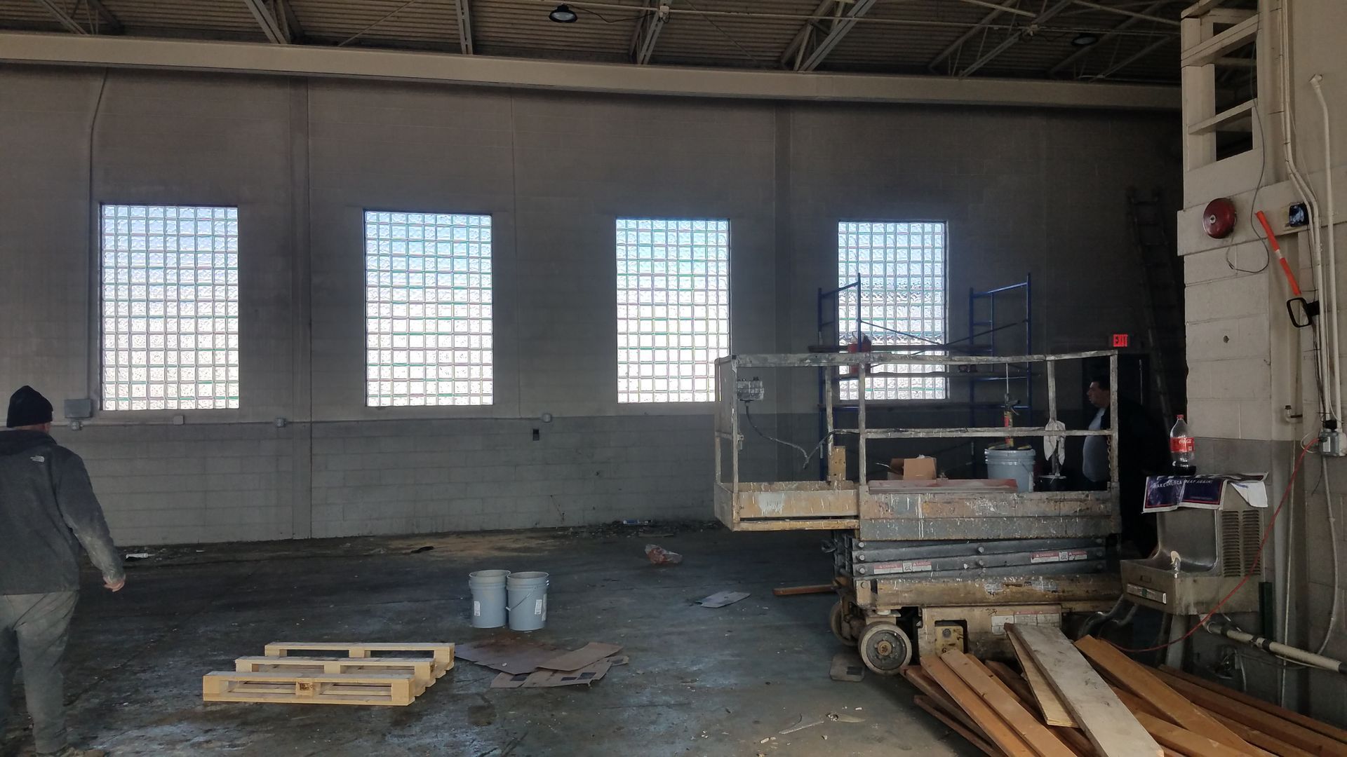 A man is standing in an empty building next to a lift.