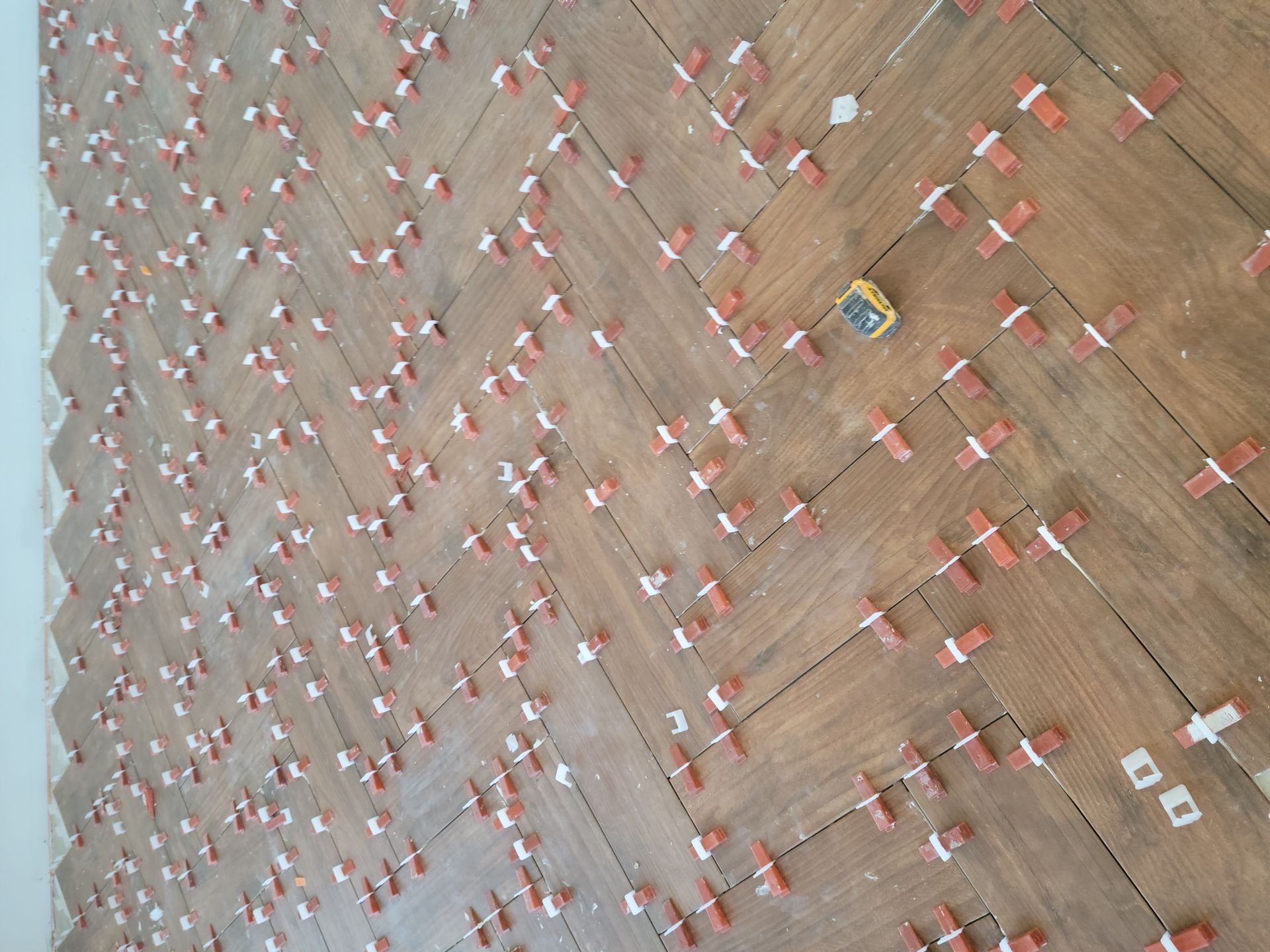 A wooden floor with a lot of tiles on it.