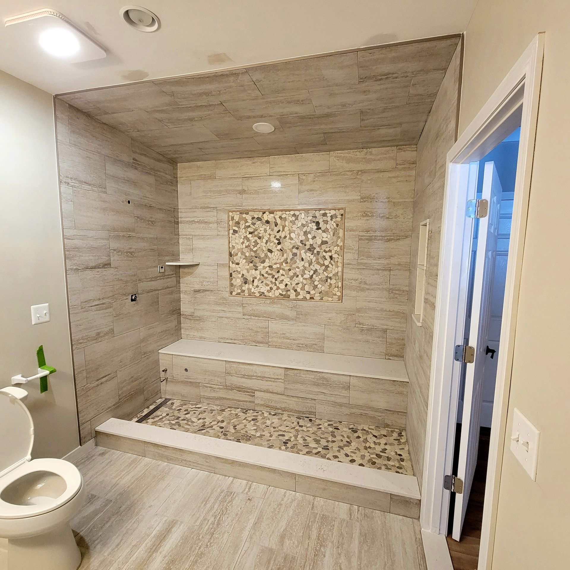 A bathroom with a toilet and a walk in shower