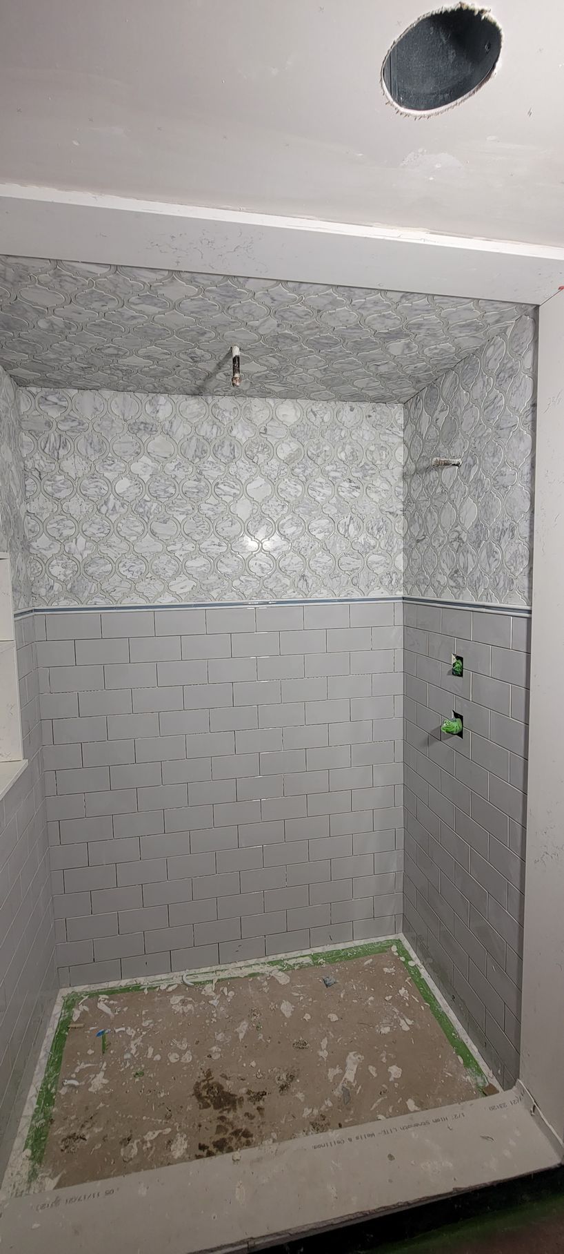 A shower stall is being built in a bathroom.