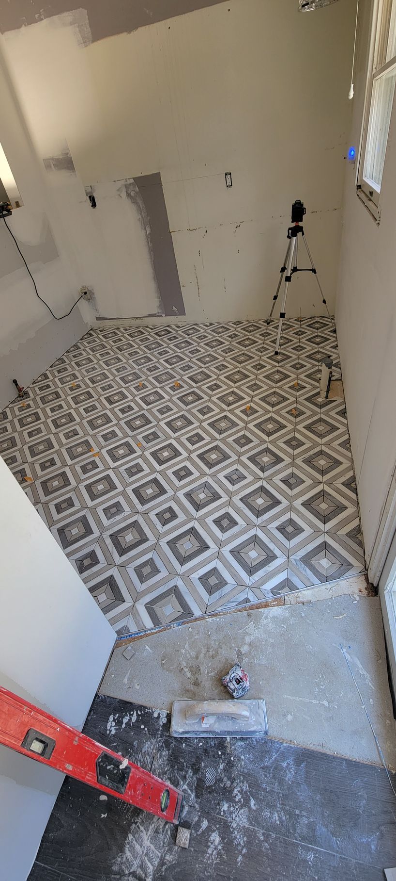 A room with a tiled floor and a level in it.