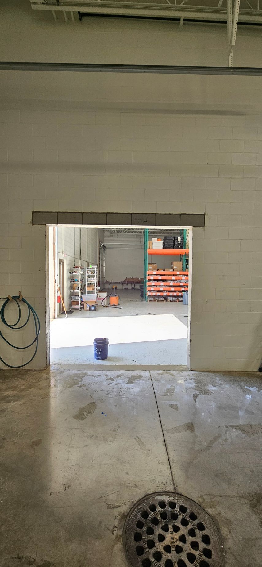 A view of a warehouse through a doorway in a building.