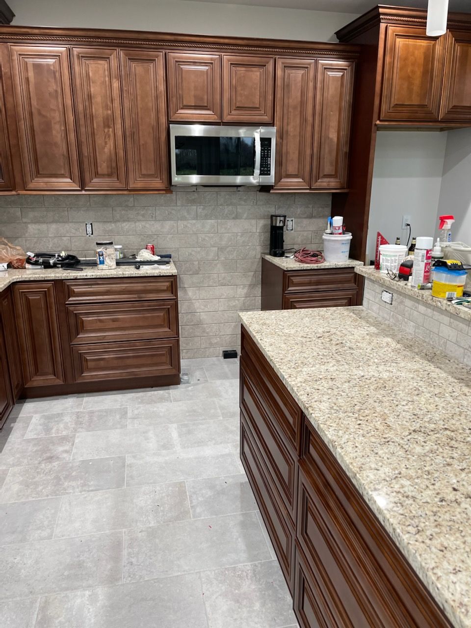 A kitchen with wooden cabinets and granite counter tops