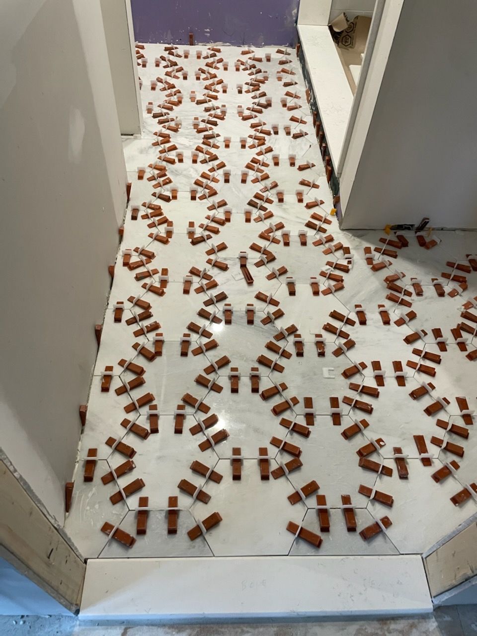 A tile floor with a pattern of bricks on it