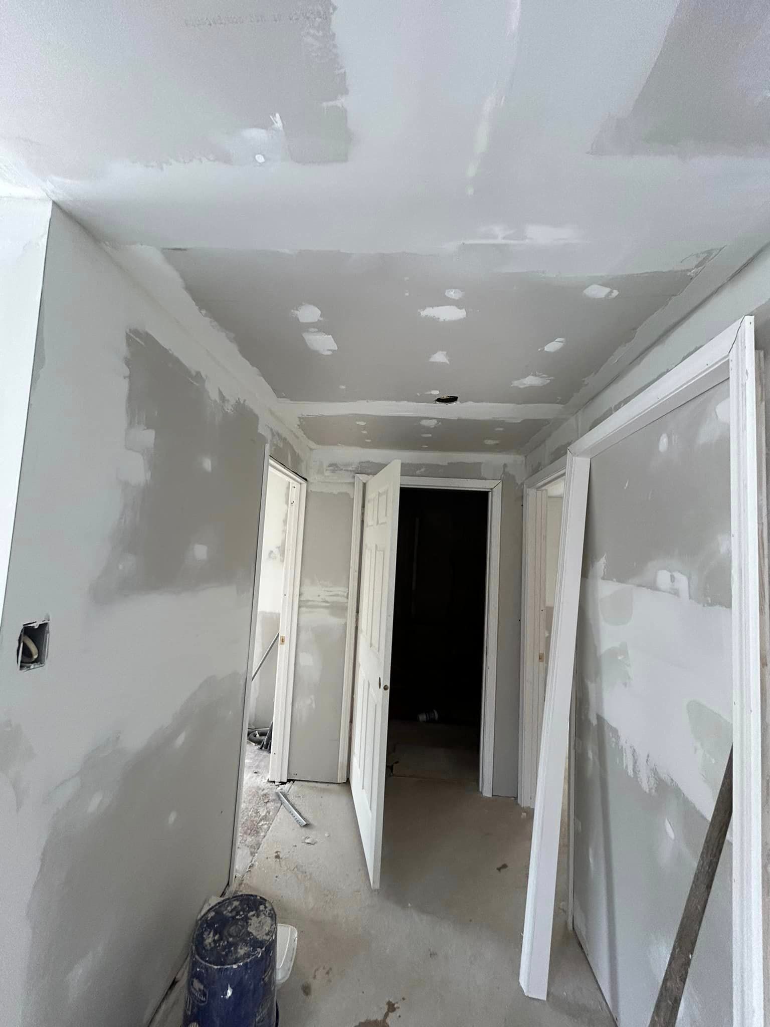 A hallway with a ceiling that is being remodeled.