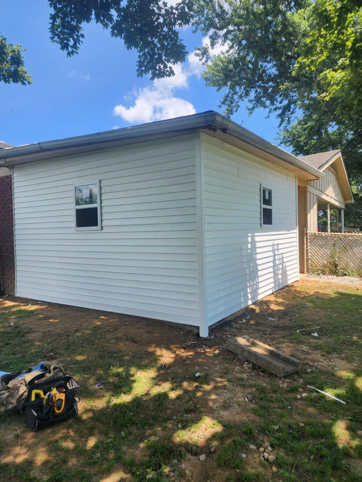A small white house is being built in the backyard.