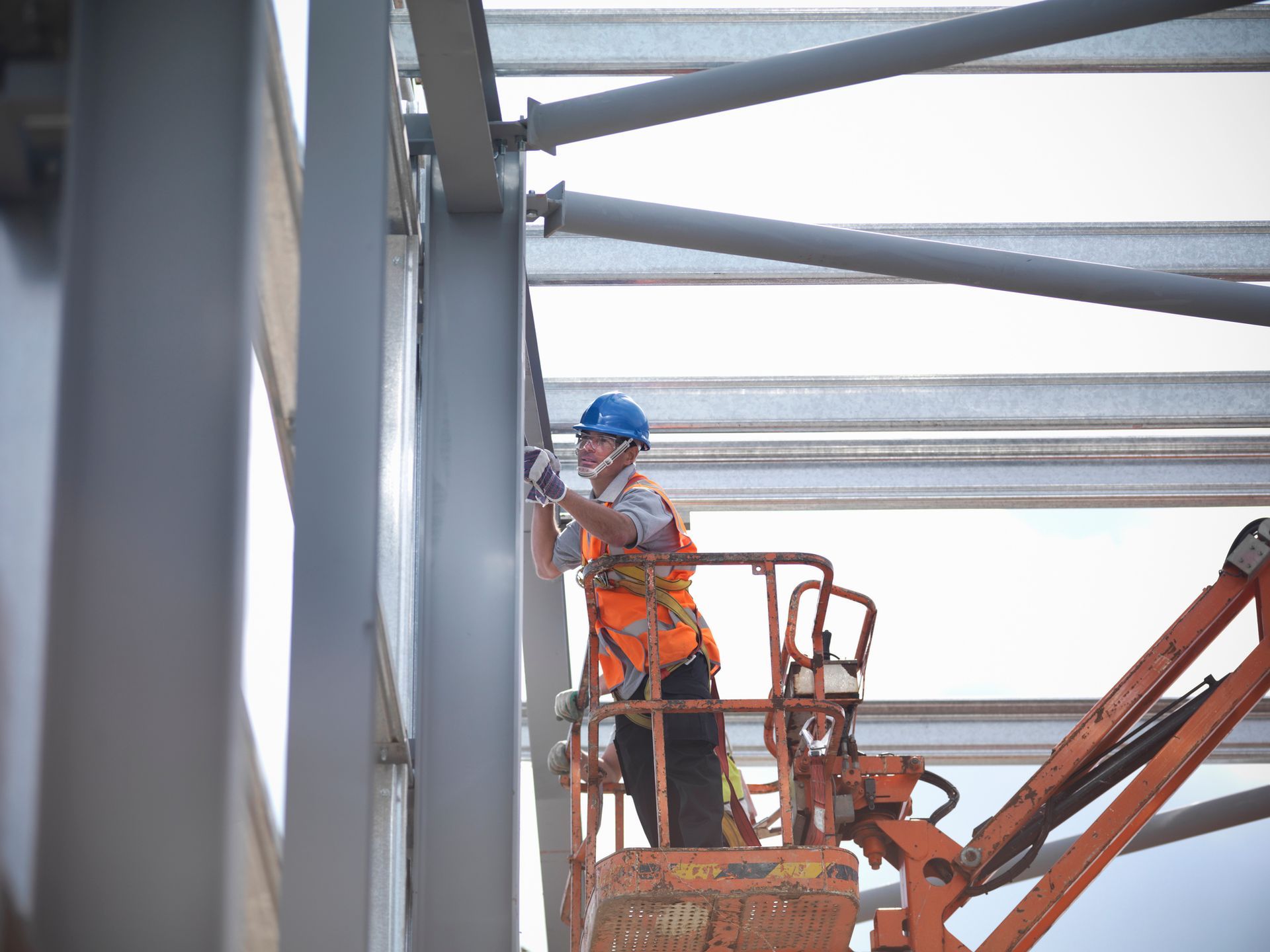 Construction workers in a boom lift.