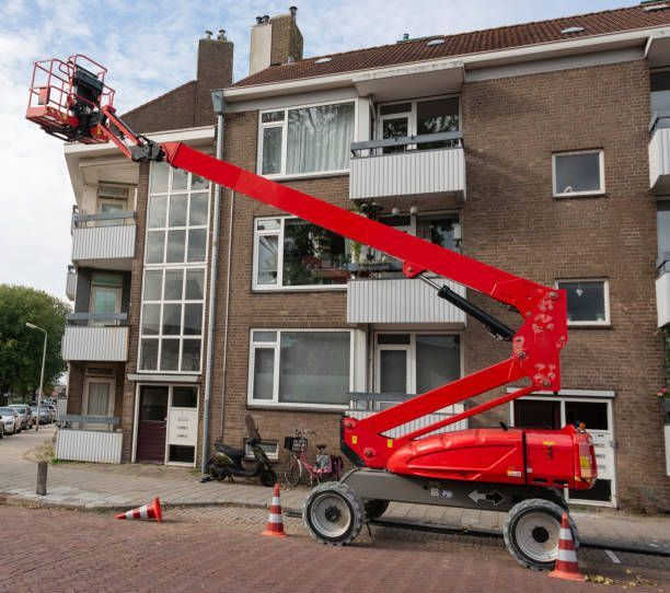 Red mobile elevating platform with cage.