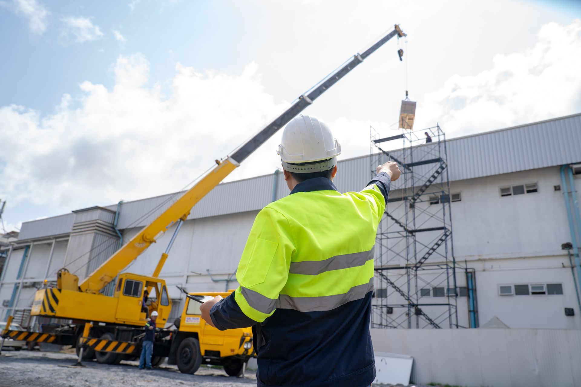 Engineers lifting loads with a large boom lift.