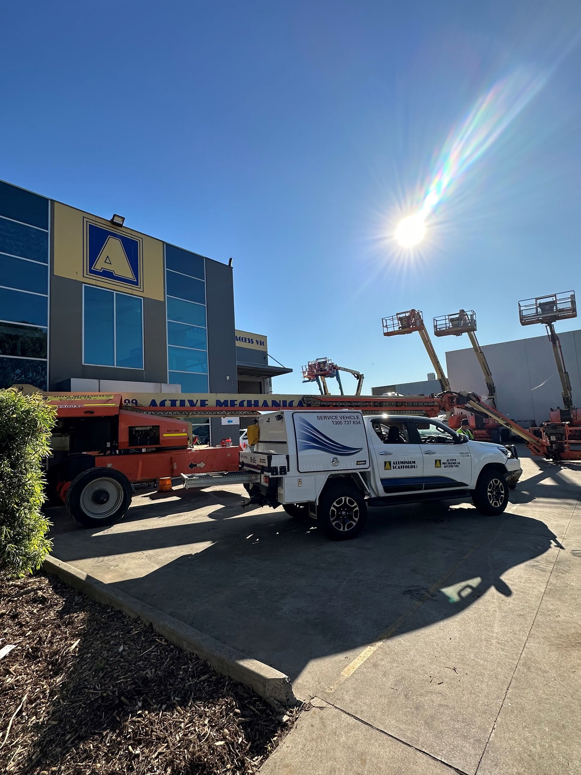 A semi truck with a crane on the back of it