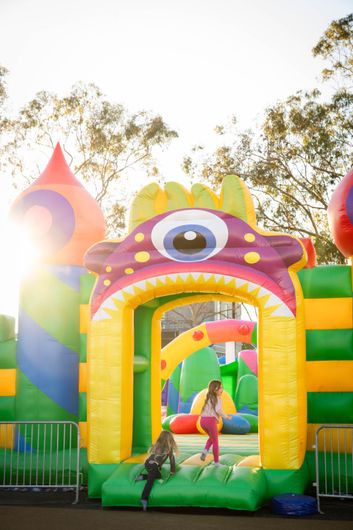 A group of children are playing in an inflatable castle.