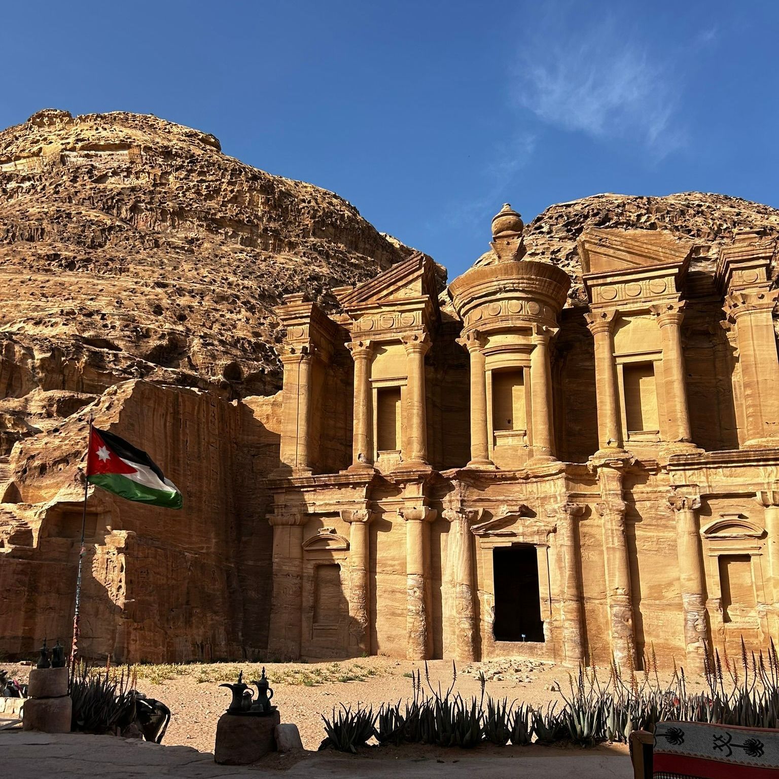 Nabatean structure in Petra called the Monastery with a flag in front of it