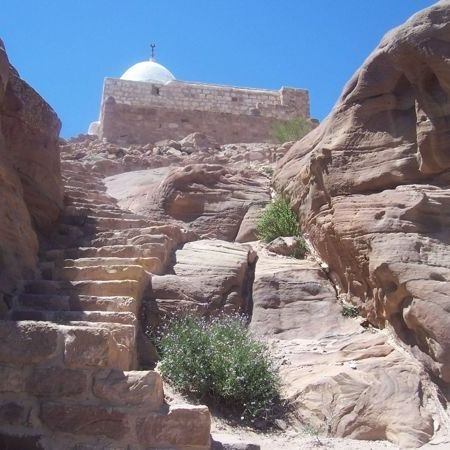 Stairs leading up to a building with a dome on top at Jabal Haroun