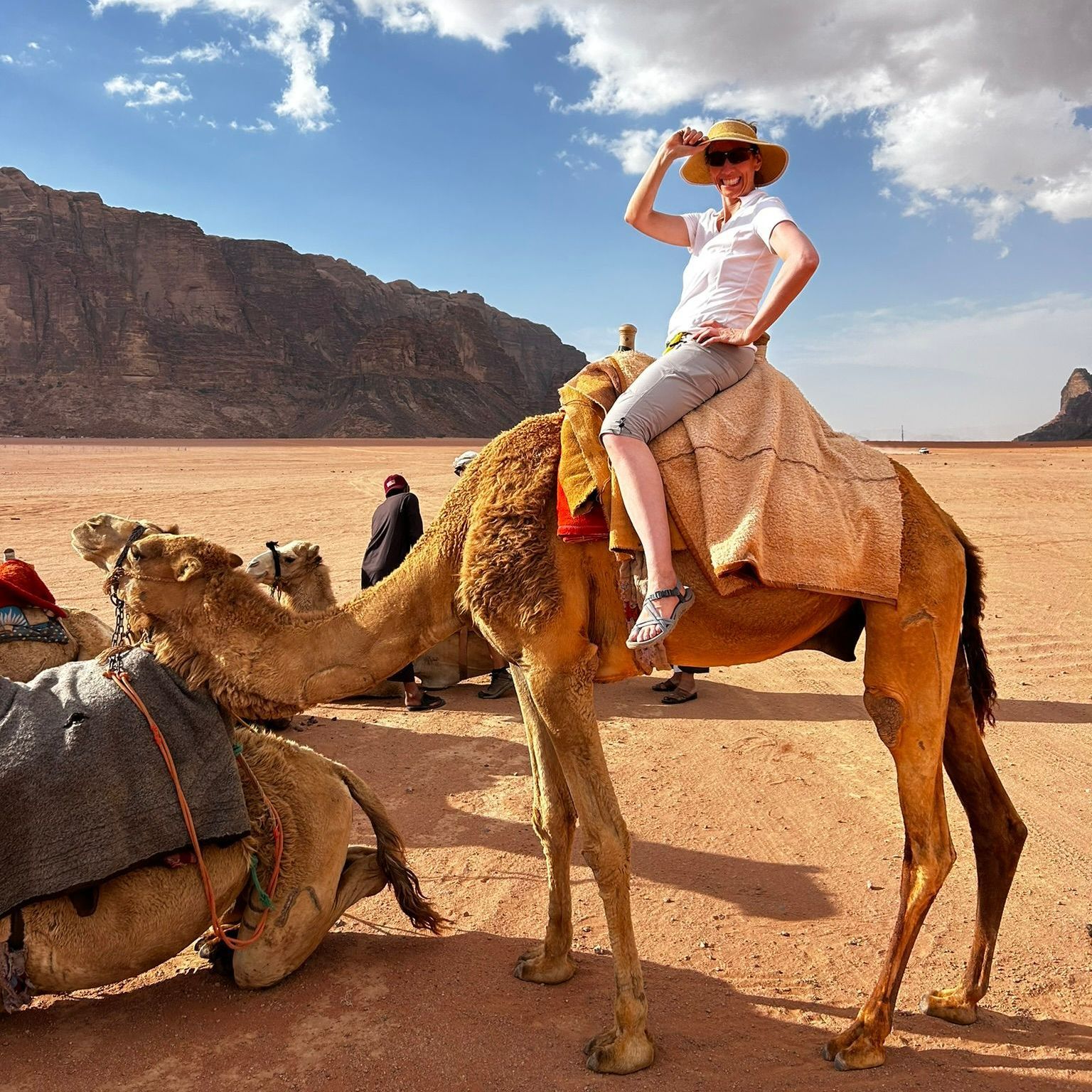 A woman is riding a camel in the Wadi Rum